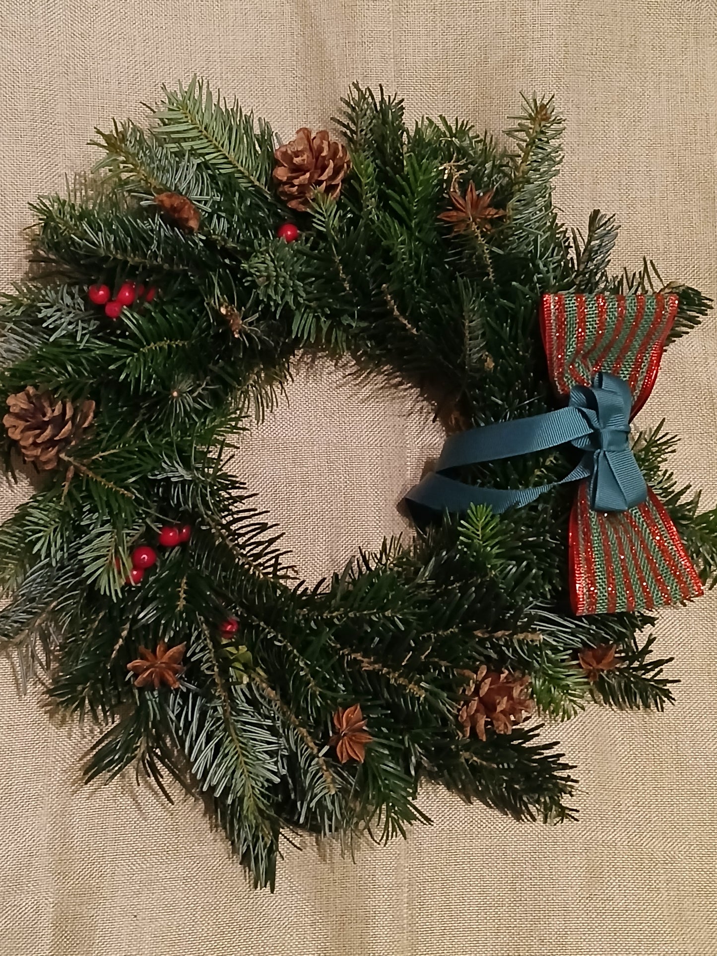 Real door wreath with decorations in red, gold, green, woodland, cinnamon, and orange, for christmas delivery 