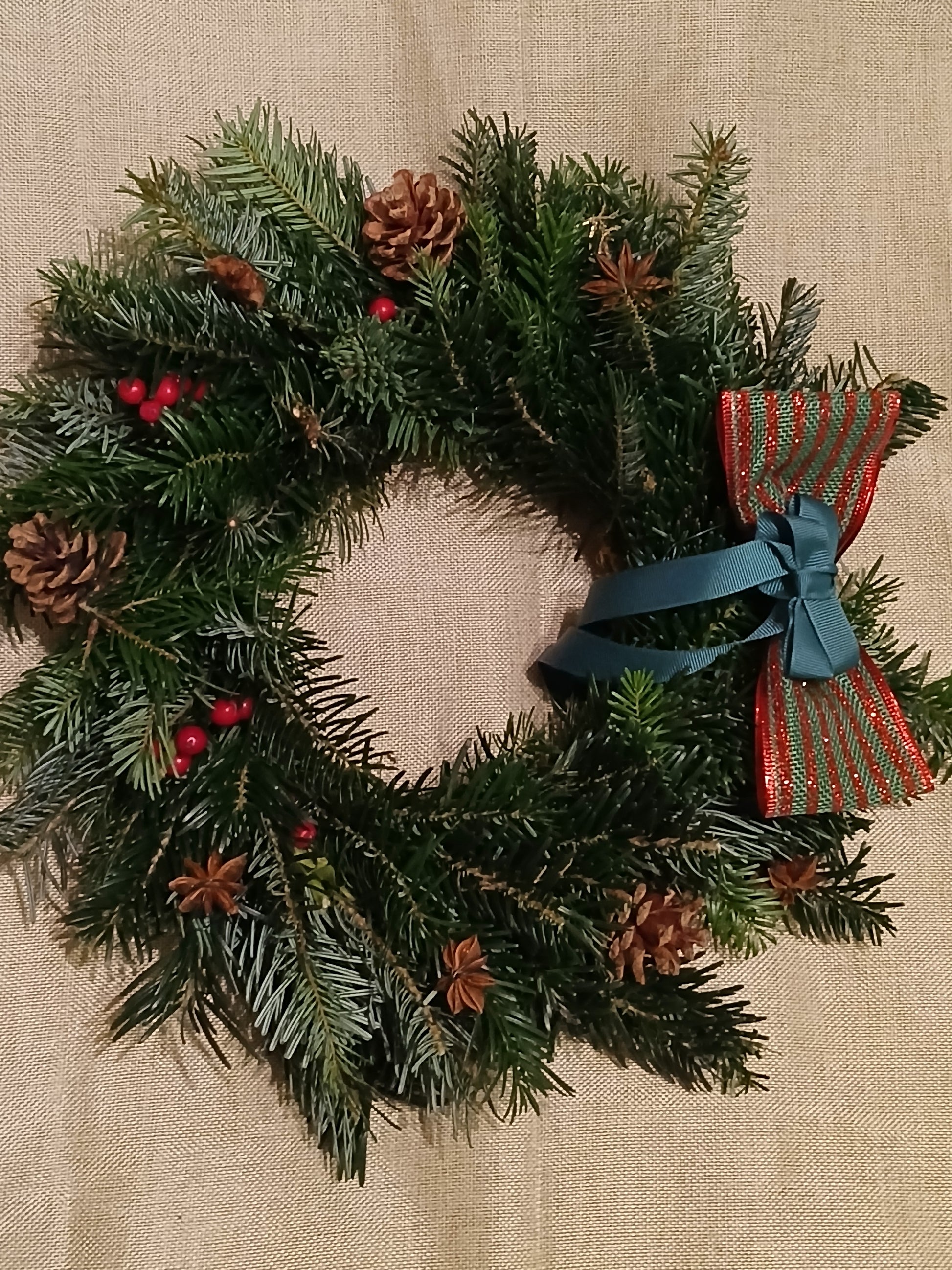 Real door wreath with decorations in red, gold, green, woodland, cinnamon, and orange, for christmas delivery 